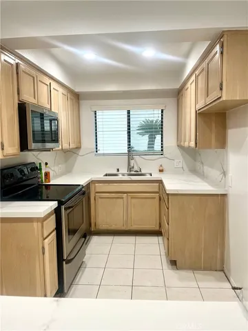 a kitchen with a sink cabinets and window