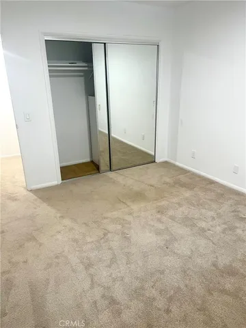 an empty room with closet area