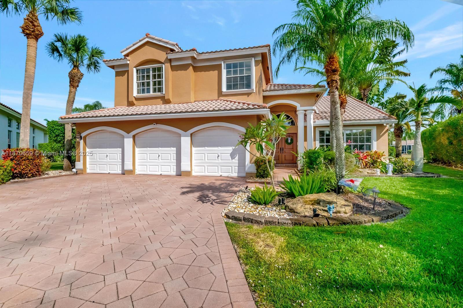 a front view of a house with a garden and plants