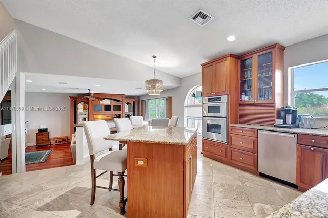 a living room with furniture a ceiling fan and a large window