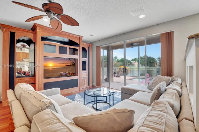 a spacious bedroom with a bed and a flat tv screen on the dresser