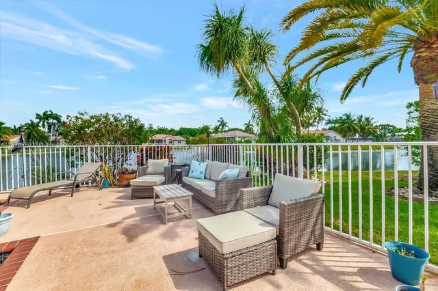 a living room with table chairs and a large window