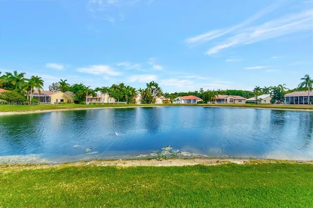 an aerial view of multiple houses with yard