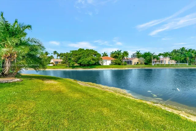 a living room with furniture kitchen view and a chandelier