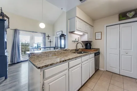 a kitchen with a sink and a refrigerator