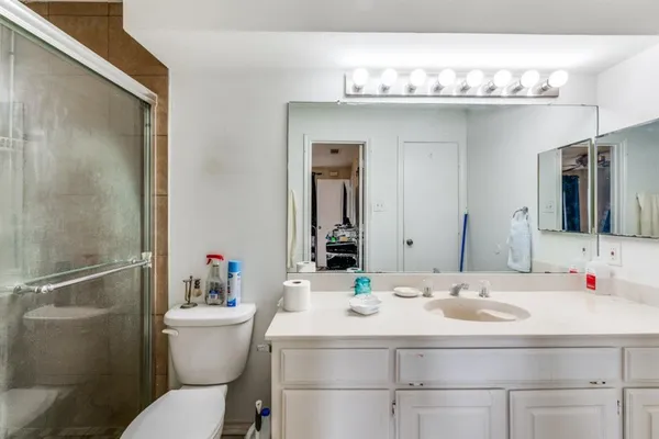 a bathroom with a sink toilet and shower