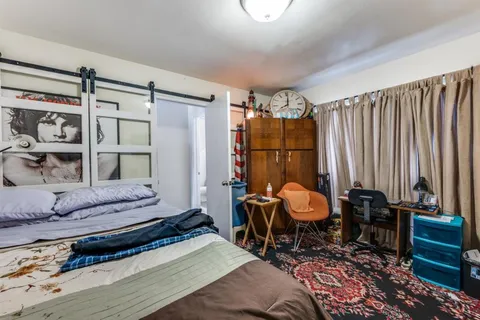 a bedroom with furniture and a chair