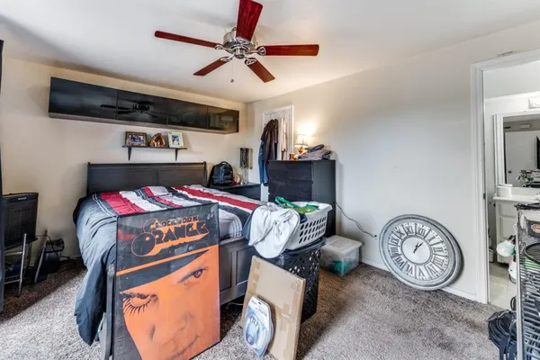a bedroom with a bed and a chandelier