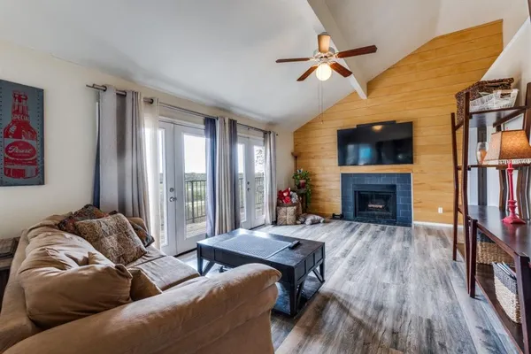 a living room with furniture fireplace and a window