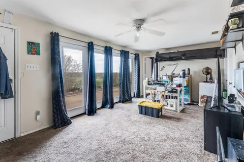 a bedroom with furniture and natural light