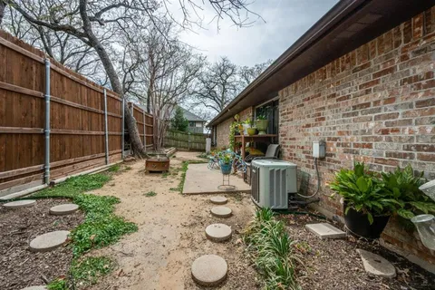 a view of a backyard with furniture and a grill