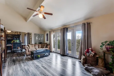 a living room with furniture and wooden floor
