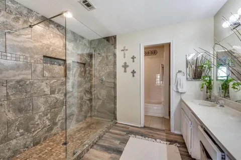 a bathroom with a shower and a sink