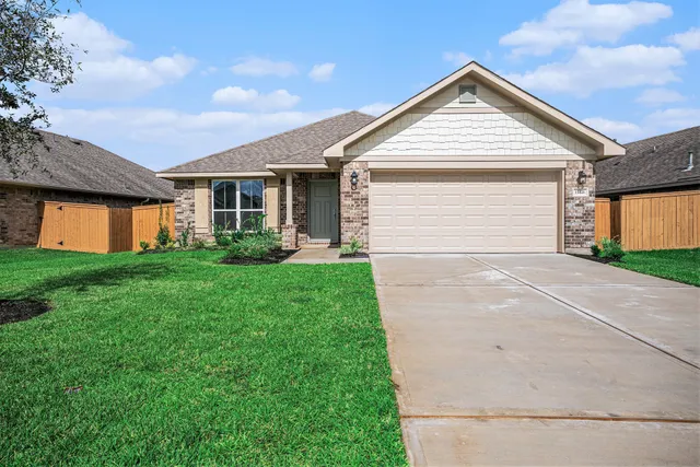 a view of a house with a yard and garage