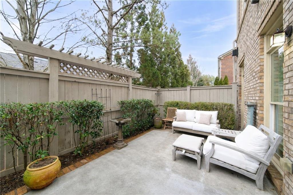 5564 High Point Road Northeast Atlanta, GA 30342 - Photo 19 of 45 a view of a patio with couches and a table and chairs with wooden fence