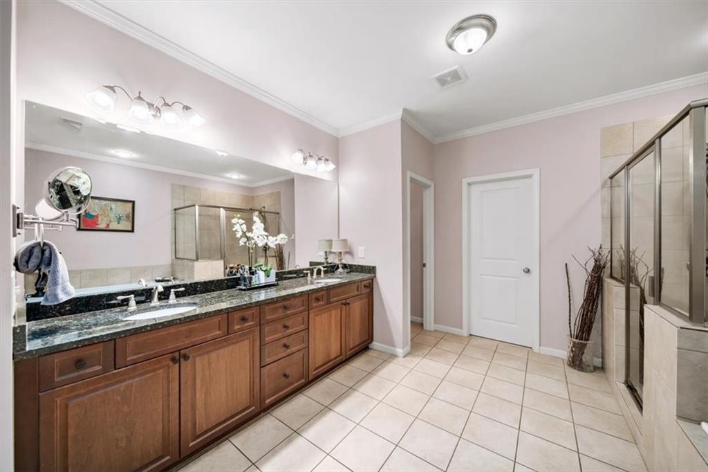 5564 High Point Road Northeast Atlanta, GA 30342 - Photo 24 of 45 a large bathroom with a granite countertop double vanity sink a mirror and a shower