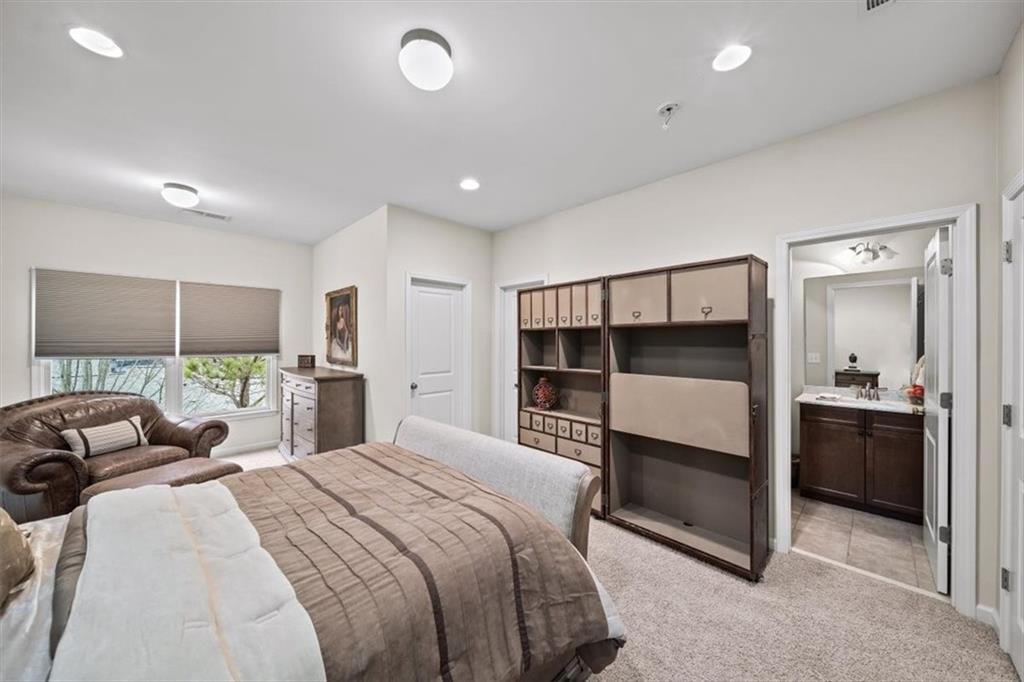 5564 High Point Road Northeast Atlanta, GA 30342 - Photo 32 of 45 a bedroom with a bed and a view of kitchen