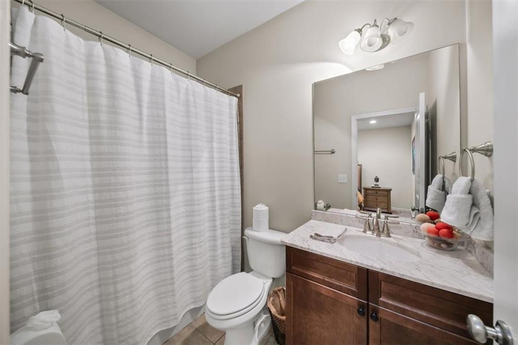 5564 High Point Road Northeast Atlanta, GA 30342 - Photo 33 of 45 a bathroom with a sink vanity mirror and toilet