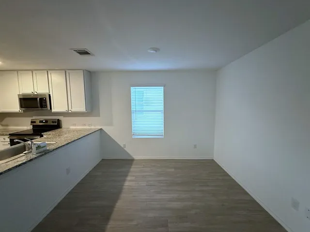 a large kitchen with a window