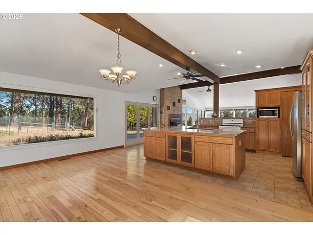 a large kitchen with a lot of counter space and stainless steel appliances