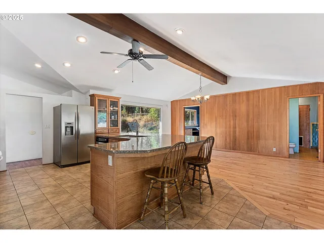 a view of a dining room with furniture and a chandelier