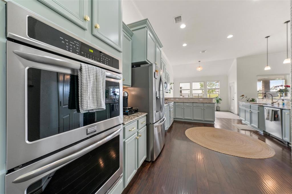 4756 Old Lorena Road Lorena, TX 76655 - Photo 11 of 39 a kitchen with stainless steel appliances kitchen island granite countertop a stove and a refrigerator