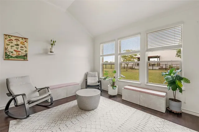 a living room with furniture a window and a potted plant