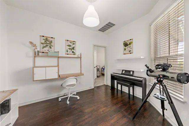 a view of a workspace with furniture and a window