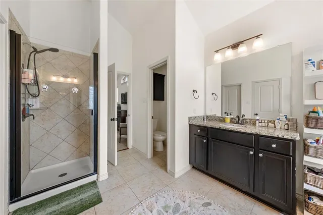 a spacious bathroom with a glass shower door and a mirror