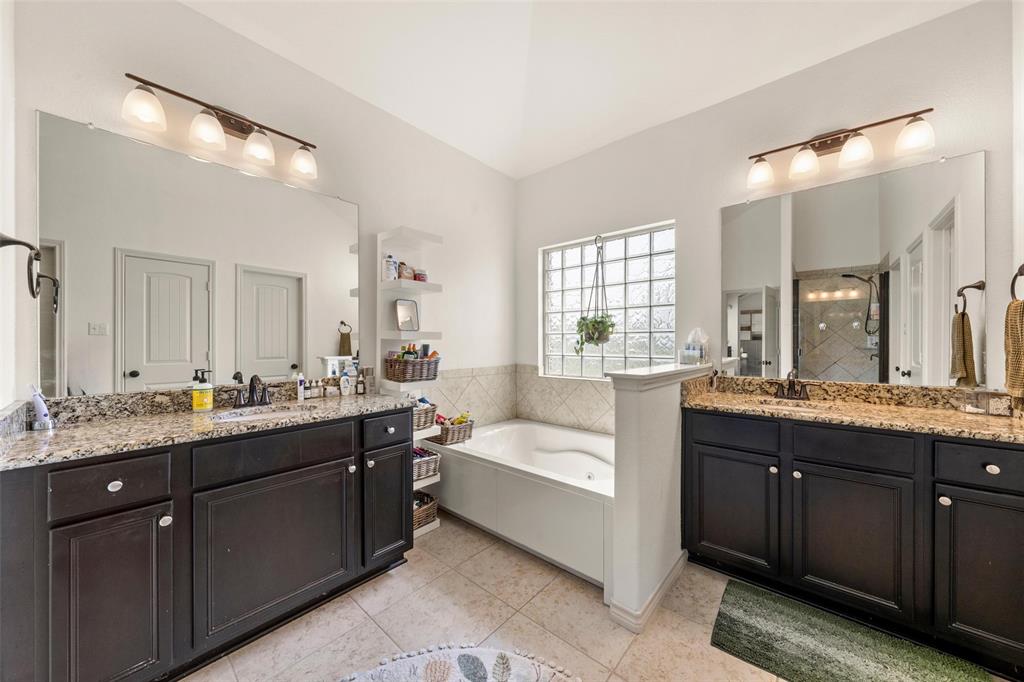 4756 Old Lorena Road Lorena, TX 76655 - Photo 21 of 39 a spacious bathroom with a granite countertop double vanity sink a mirror and a bathtub