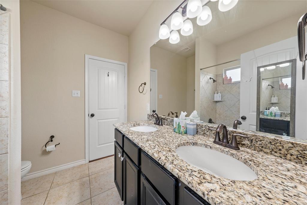 4756 Old Lorena Road Lorena, TX 76655 - Photo 24 of 39 a bathroom with a granite countertop double vanity sink and a mirror