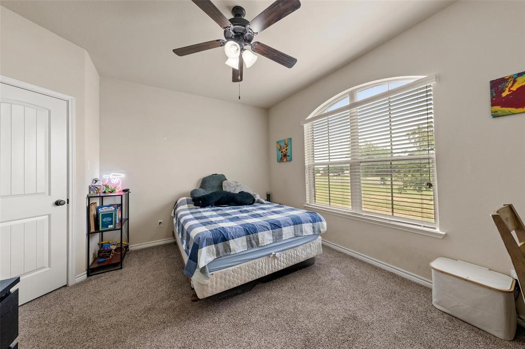4756 Old Lorena Road Lorena, TX 76655 - Photo 26 of 39 a bedroom with a bed and a chandelier