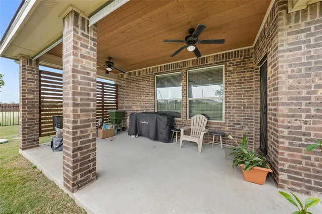 a balcony with table and chairs
