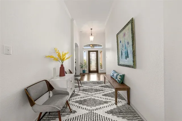 a living room with furniture and a chandelier