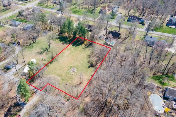 an aerial view of a house with a lake view