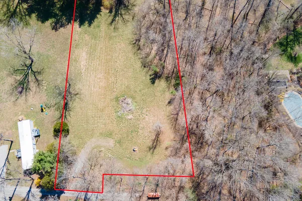 an aerial view of a house with a lake view