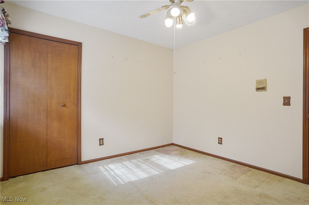 7300 Morley Road Painesville, OH 44077 - Photo 34 of 50 Unfurnished bedroom with a closet, light colored carpet, and ceiling fan
