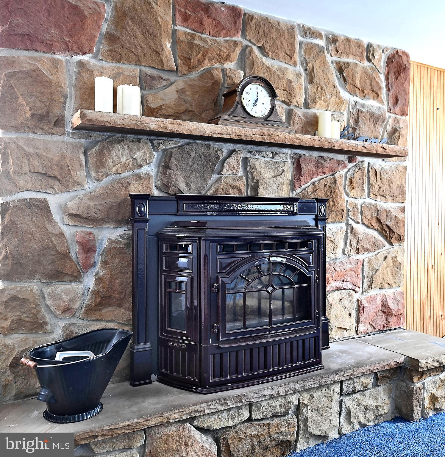 2400 Maple Road Baltimore, MD 21219 - Photo 14 of 45 a fireplace with a clock on top of it