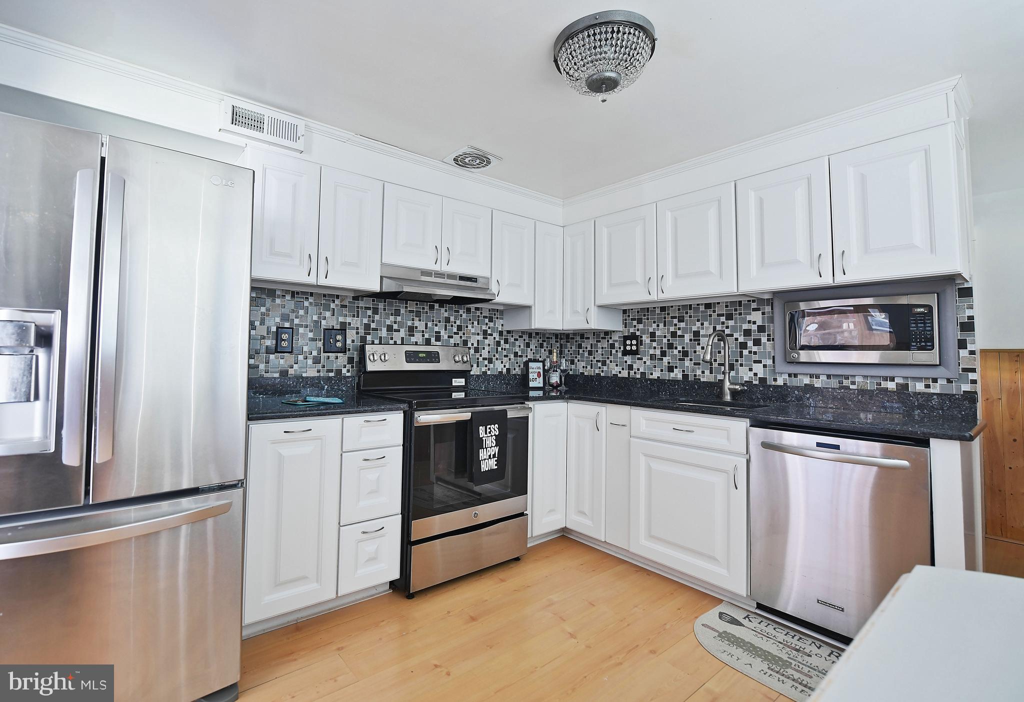 2400 Maple Road Baltimore, MD 21219 - Photo 18 of 45 a kitchen with stainless steel appliances granite countertop a stove a sink and a refrigerator