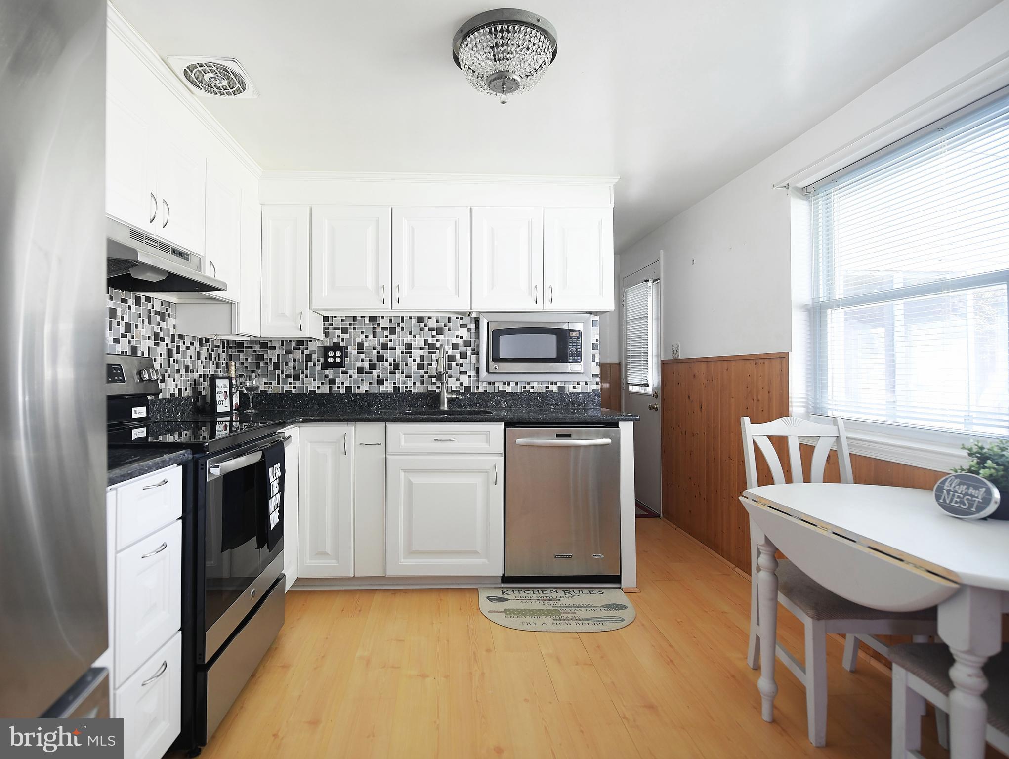 2400 Maple Road Baltimore, MD 21219 - Photo 19 of 45 a kitchen with granite countertop a sink appliances cabinets and furniture