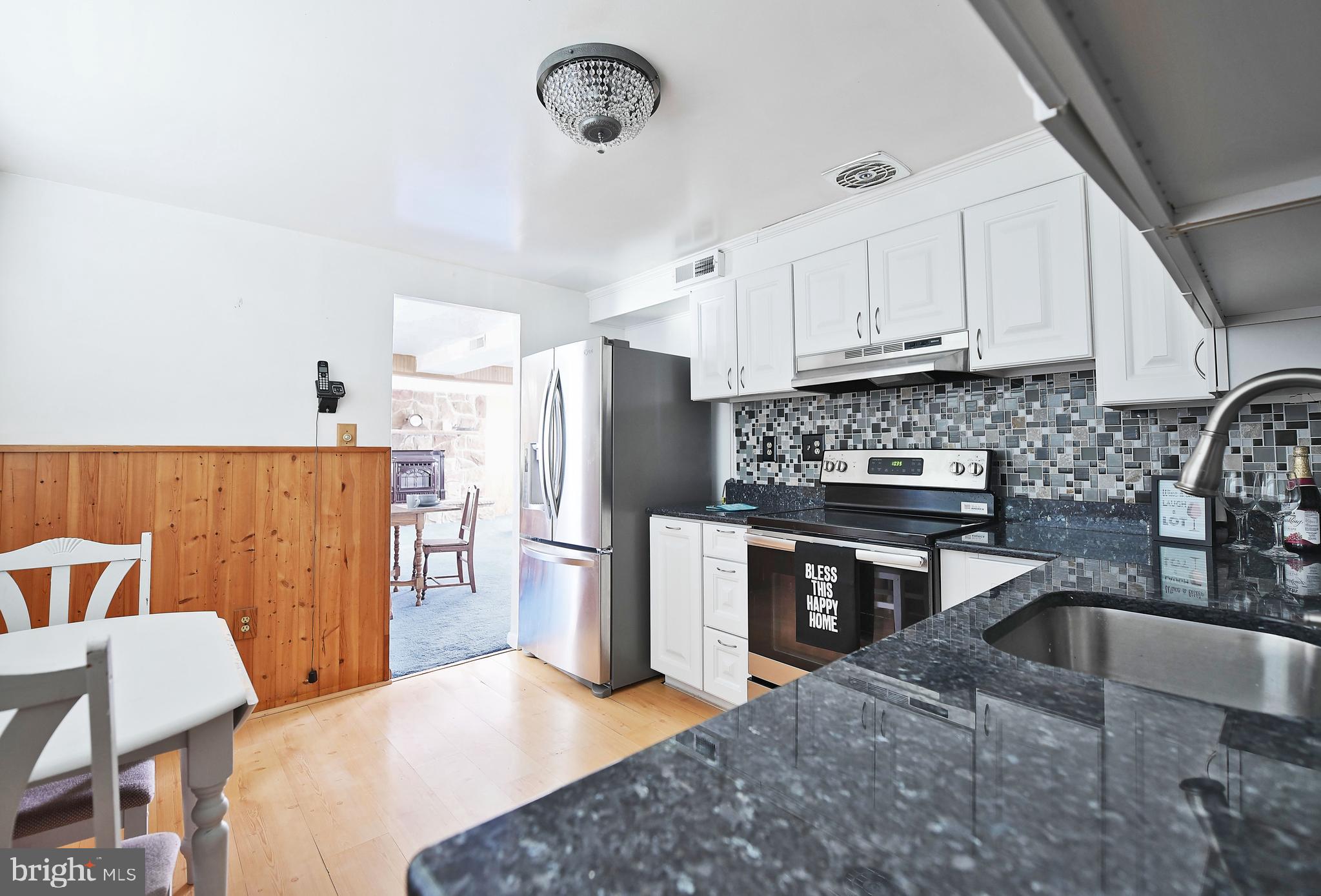 2400 Maple Road Baltimore, MD 21219 - Photo 20 of 45 a kitchen with stainless steel appliances granite countertop a sink a stove a refrigerator a counter space and stainless steel appliances