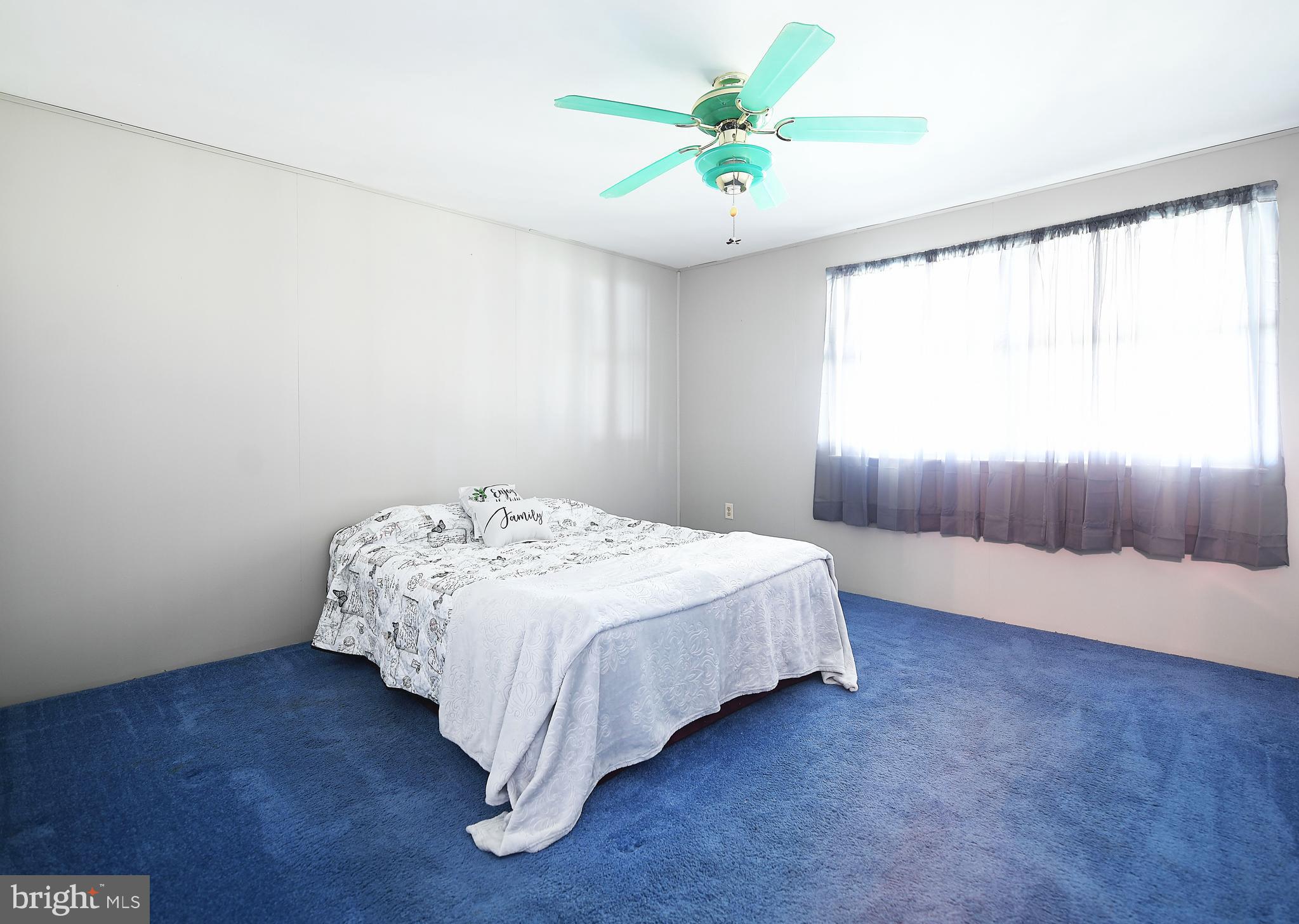 2400 Maple Road Baltimore, MD 21219 - Photo 24 of 45 a bedroom with a bed and a chandelier