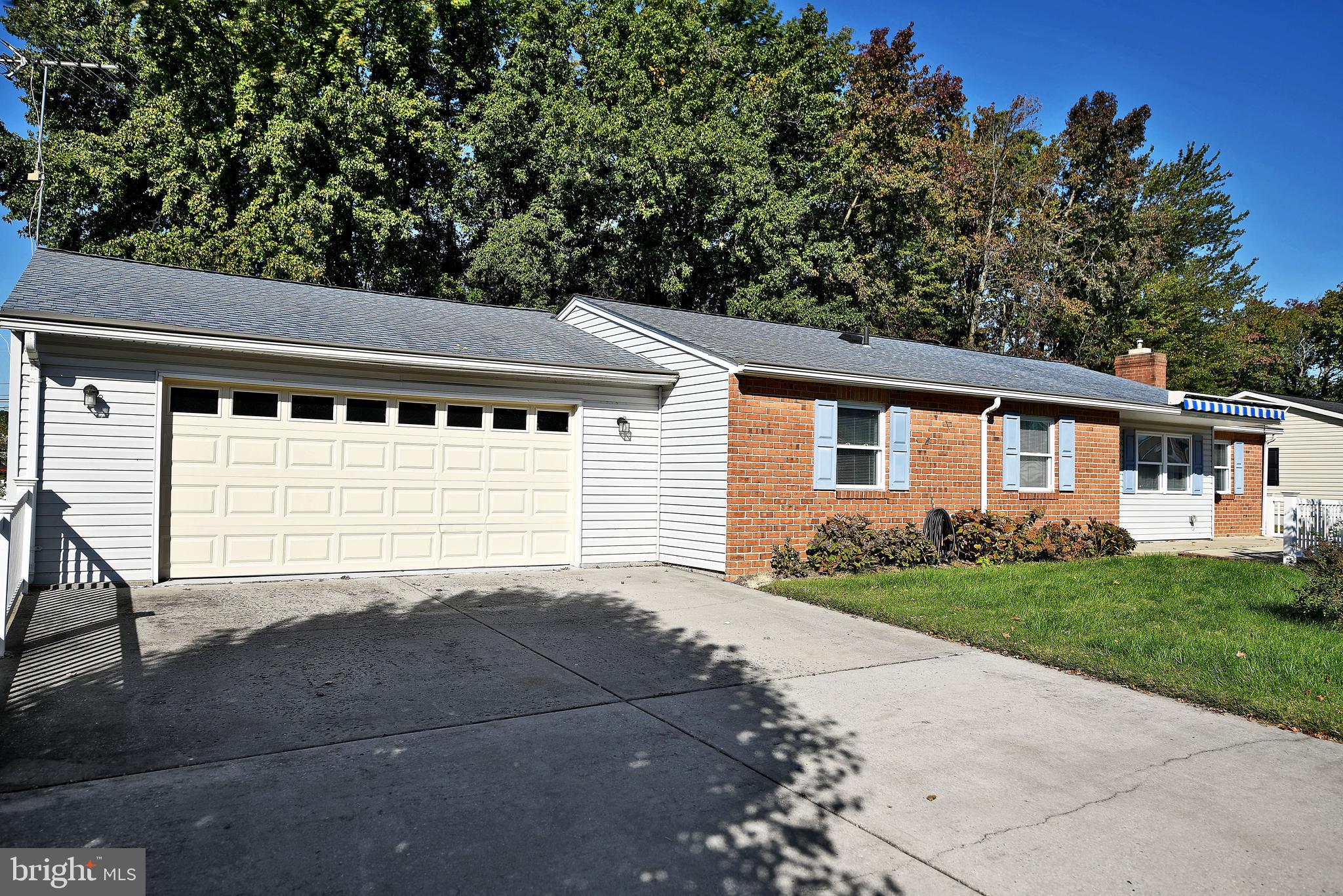 2400 Maple Road Baltimore, MD 21219 - Photo 44 of 45 a front view of a house with a yard and garage