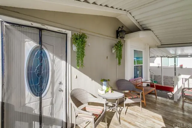 a dining room with furniture and a floor to ceiling window