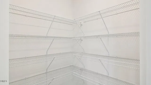 a kitchen with cabinets and wooden floor