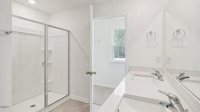a bathroom with a glass shower door