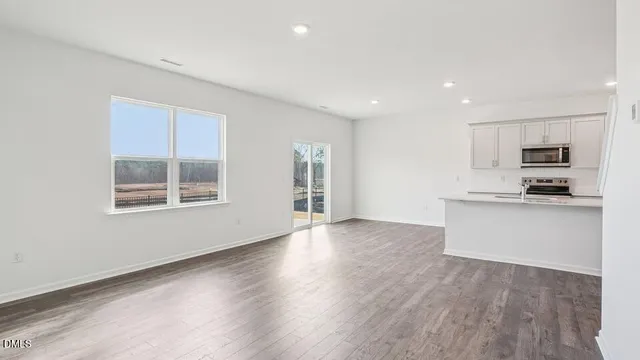 a view of kitchen with granite countertop cabinets and wooden floor
