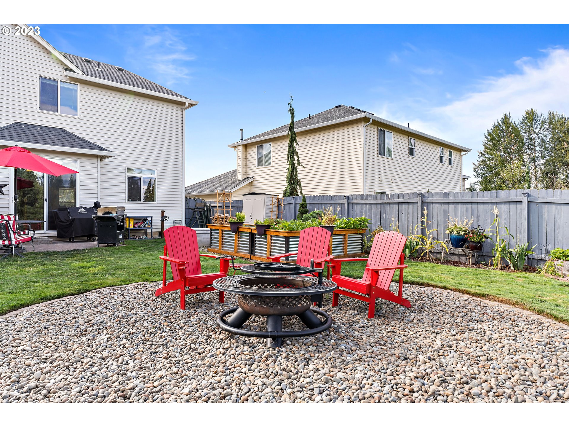 604 North 22nd Court Ridgefield, WA 98642 - Photo 33 of 40 a backyard of a house with barbeque oven table and chairs