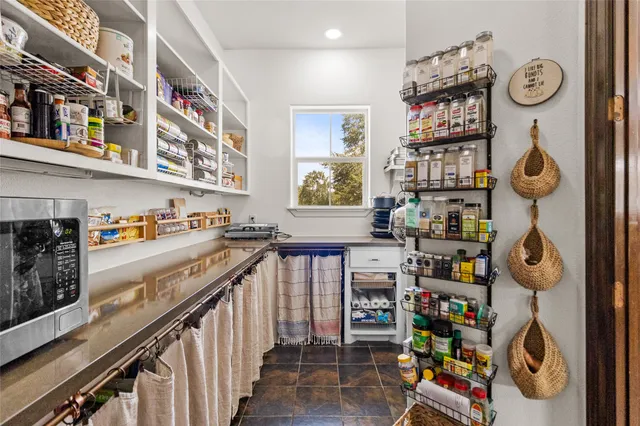 a utility room with lots of clutter and cabinets