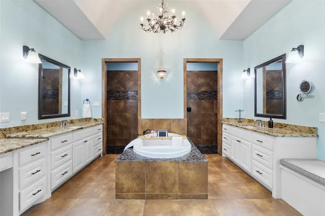 a spacious bathroom with a granite countertop sink mirror and shower